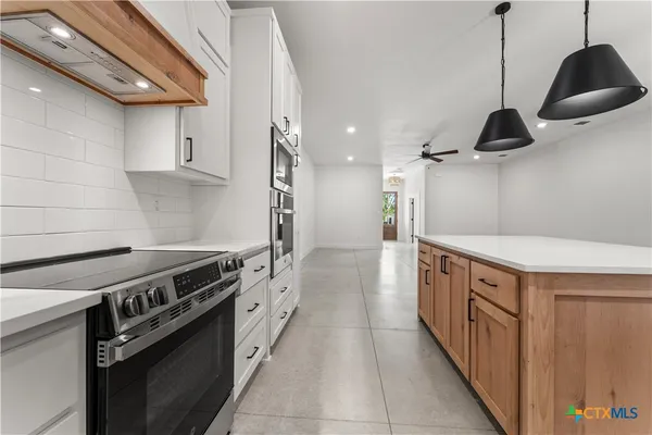 a kitchen with stainless steel appliances a stove and a refrigerator