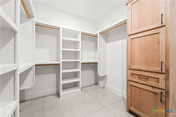a view of cabinets and closet with wooden floor