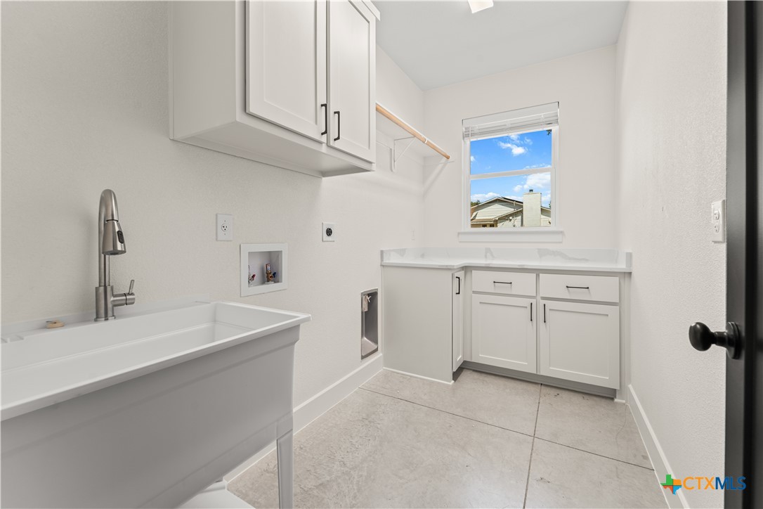 3244 Lois Lane Kempner, TX 76539 - Photo 27 of 35 a kitchen with white cabinets and a sink