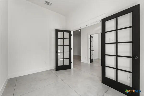 an empty room with windows and closet