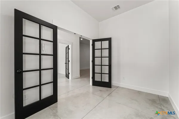 a view of an empty room with a window