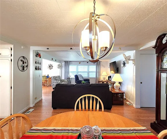 a living room with furniture a fireplace and a chandelier