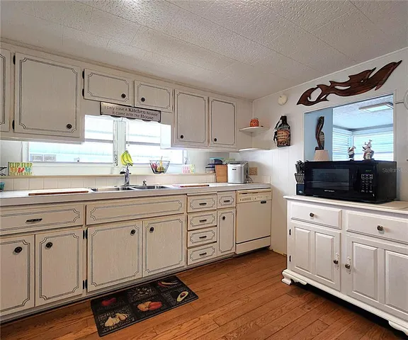 a kitchen with appliances cabinets and a window