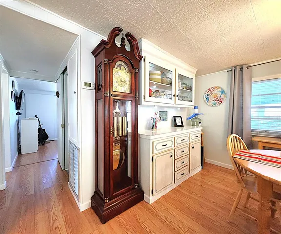 a bedroom with a bed and a mirror on the dresser