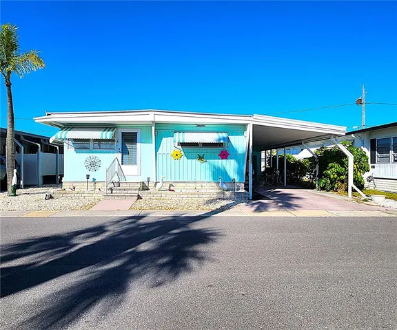 a view of a house with backyard porch and sitting area