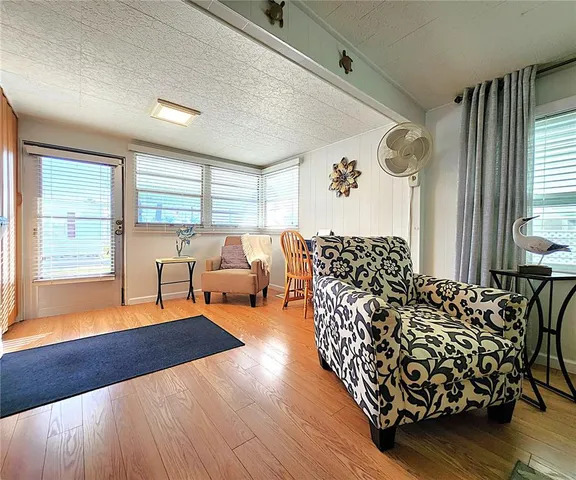 a living room with furniture window and wooden floor