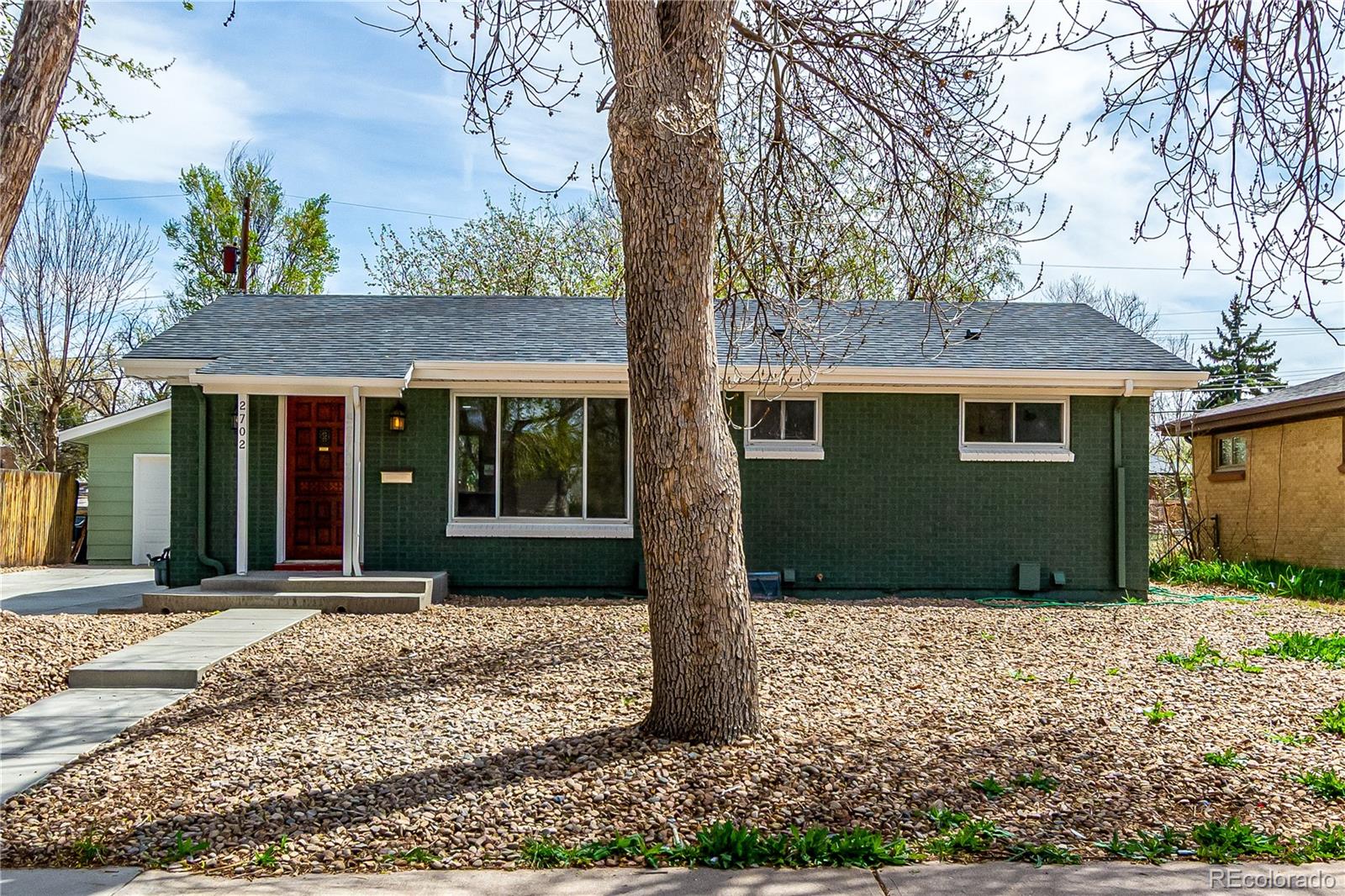 a front view of a house with a garden
