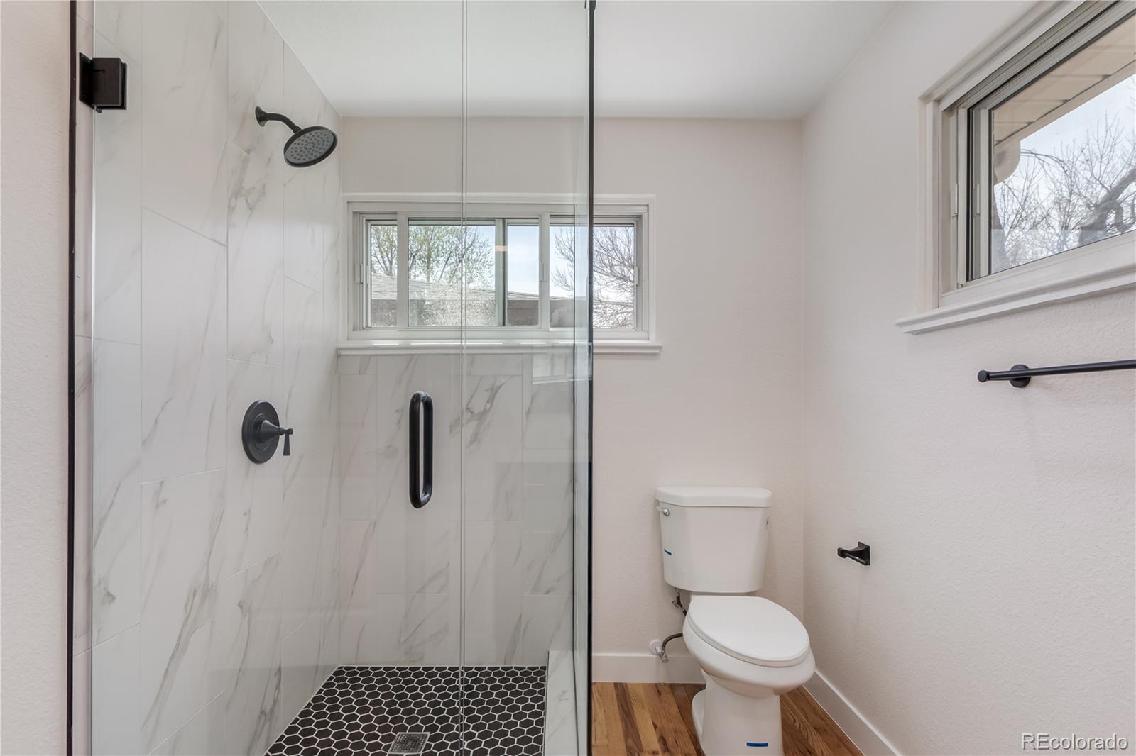 2702 Atchison Street Aurora, CO 80011 - Photo 11 of 18 a bathroom with a toilet and a shower