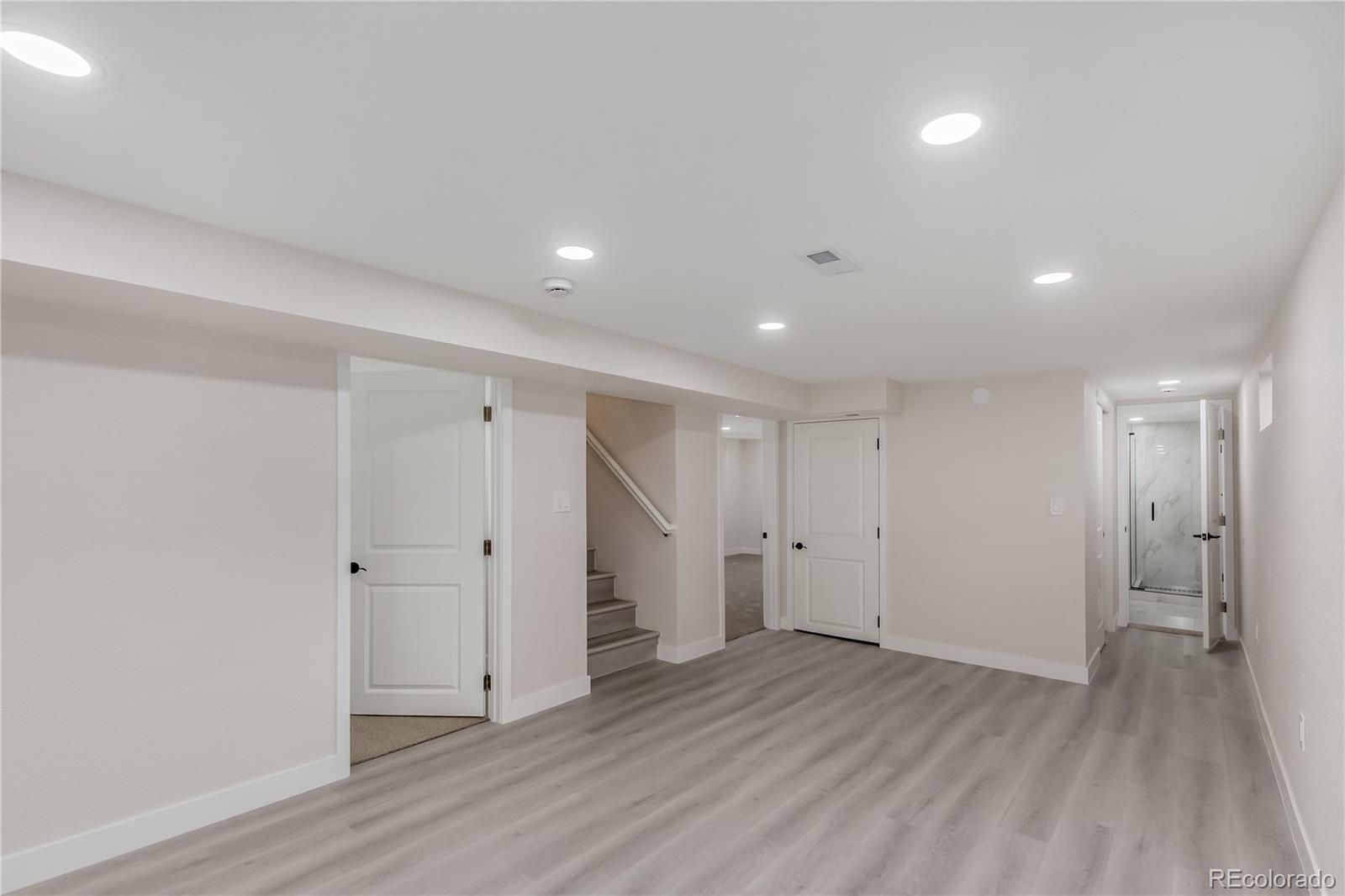 2702 Atchison Street Aurora, CO 80011 - Photo 13 of 18 a view of a big room with wooden floor