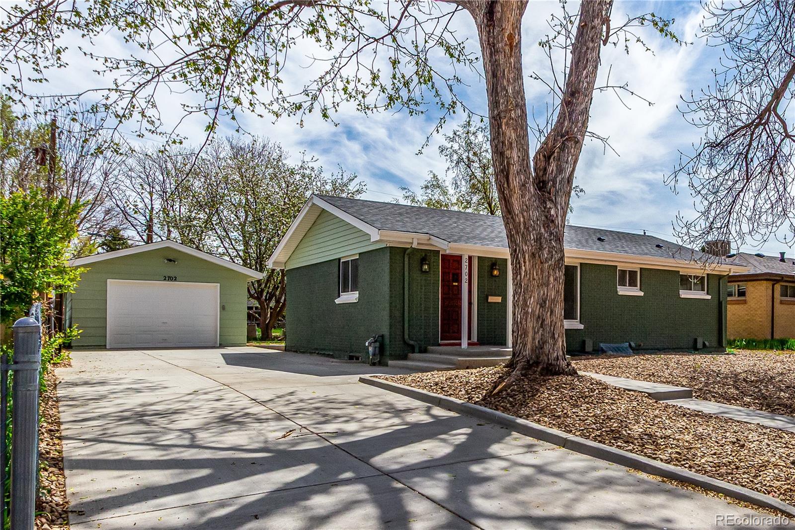 2702 Atchison Street Aurora, CO 80011 - Photo 2 of 18 a front view of a house with a yard and garage