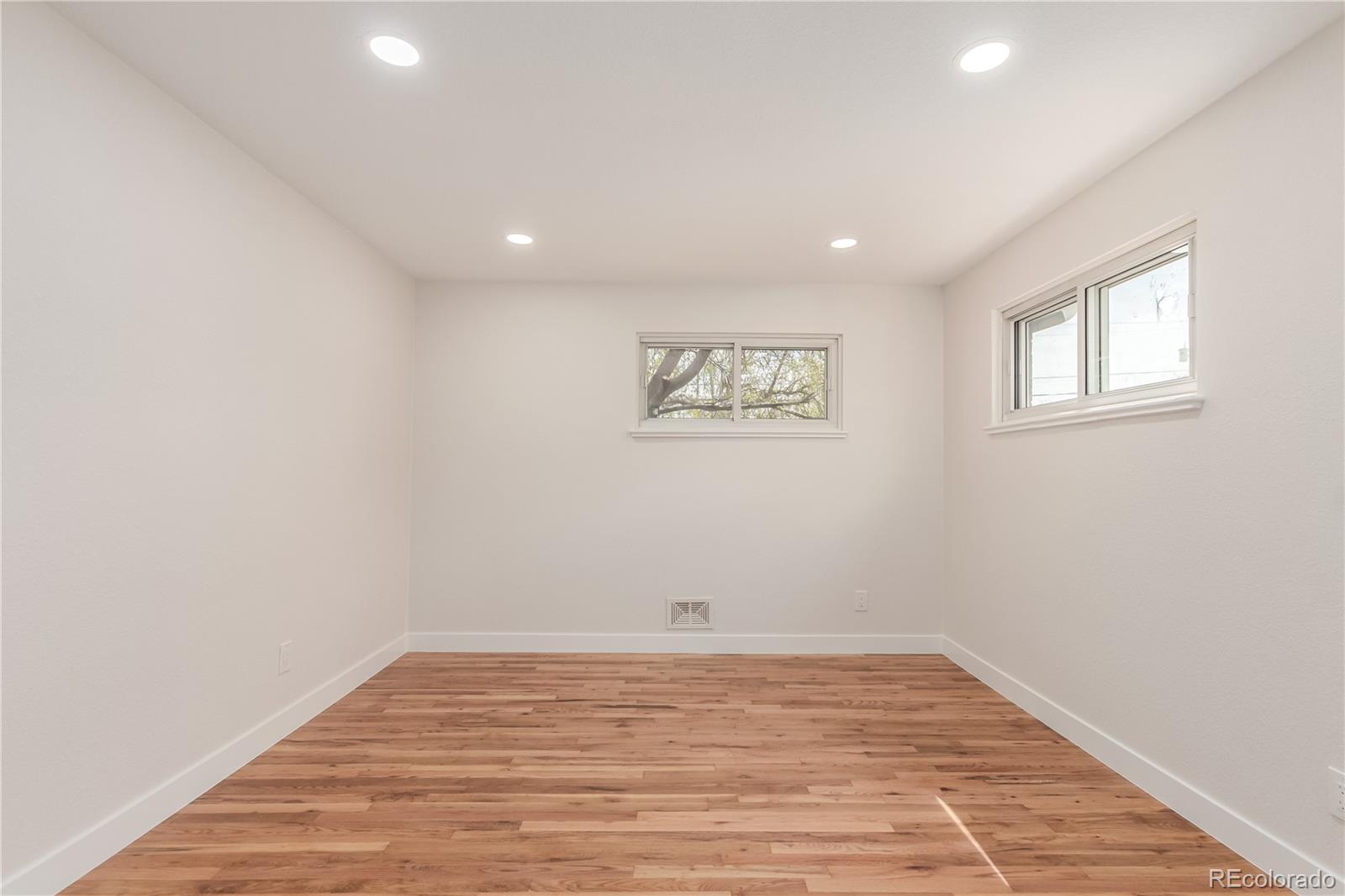 2702 Atchison Street Aurora, CO 80011 - Photo 10 of 18 a view of empty room with wooden floor