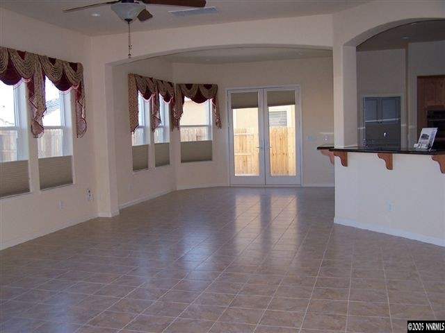 10535 Kenai Drive Reno, NV 89521 - Photo 3 of 9 a view of a hallway with wooden floor and windows