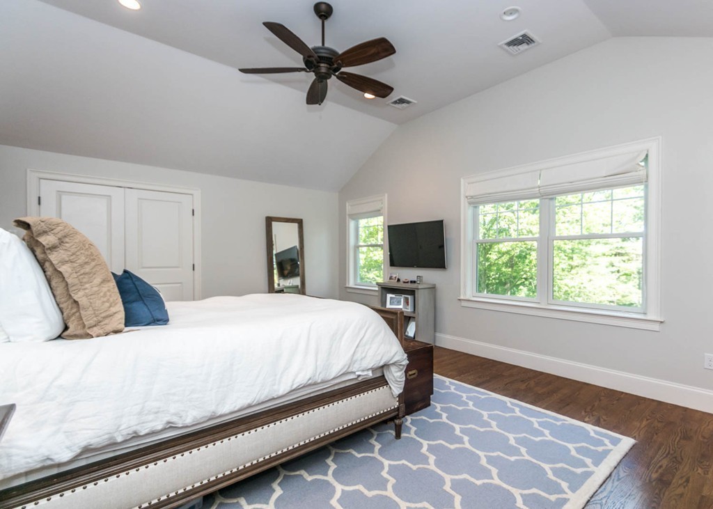 80 Lawton Road Needham, MA 02492 - Photo 19 of 30 a bedroom with a large bed and a tv