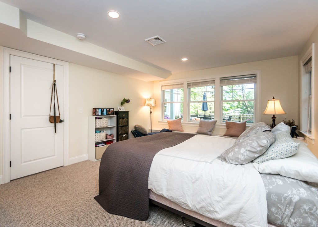80 Lawton Road Needham, MA 02492 - Photo 24 of 30 a bedroom with a large bed and a chandelier