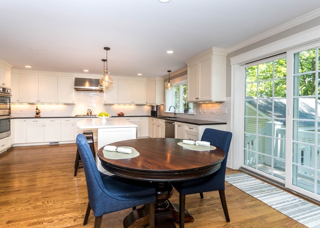 80 Lawton Road Needham, MA 02492 - Photo 9 of 30 a kitchen with a dining table chairs and wooden floor
