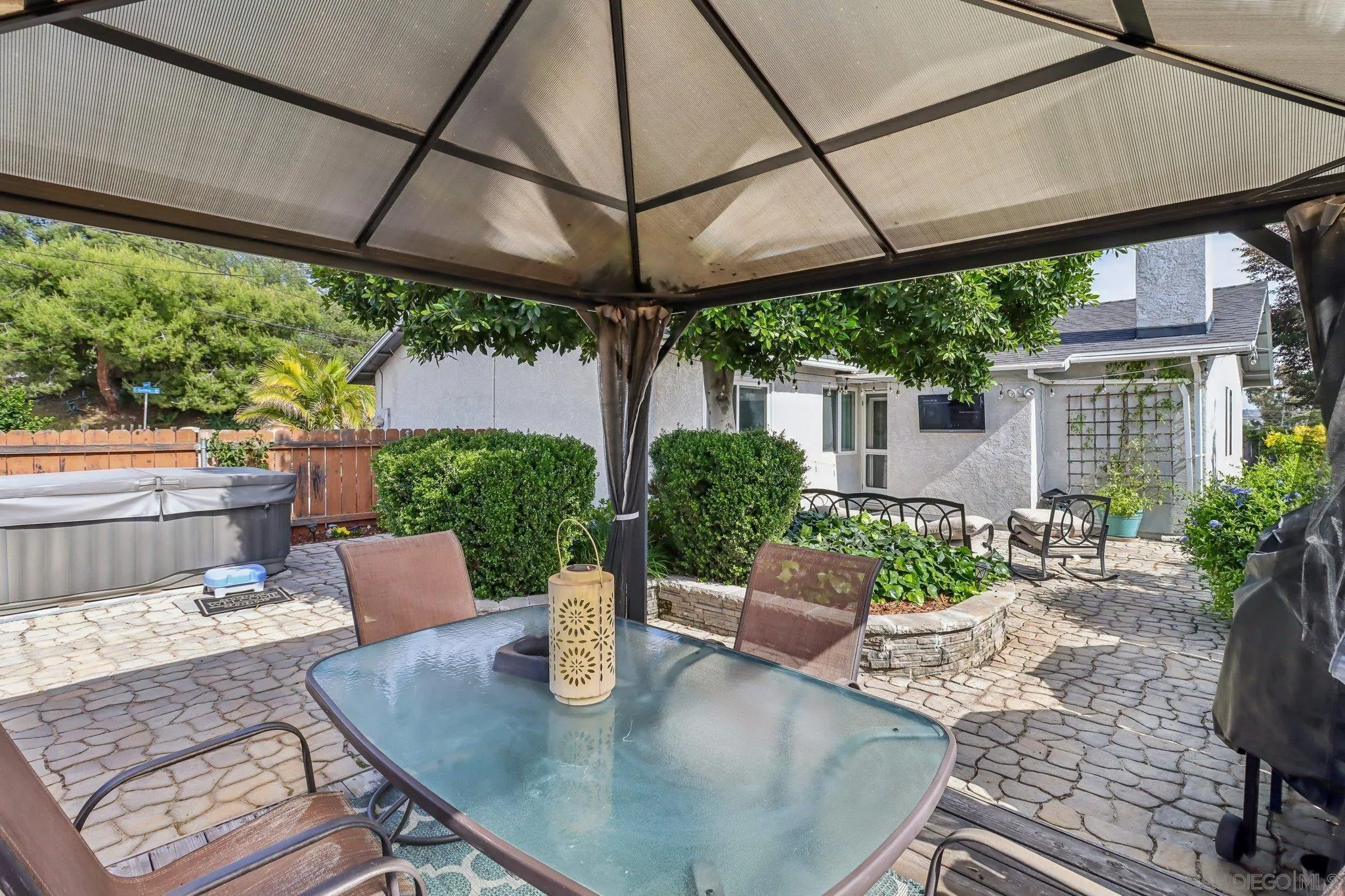 9932 Settle Road Santee, CA 92071 - Photo 15 of 53 a view of a patio with a table and chairs under an umbrella