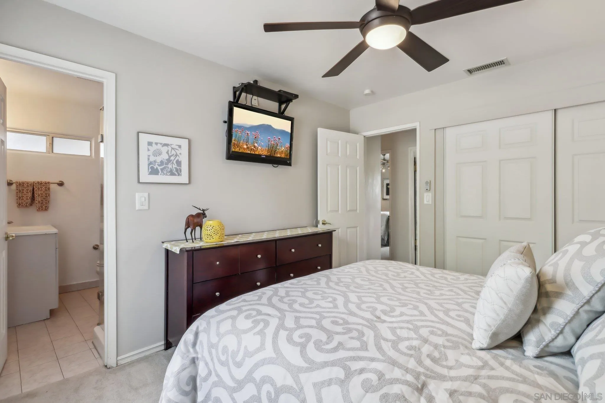 9932 Settle Road Santee, CA 92071 - Photo 26 of 53 a bedroom with a bed and a chandelier