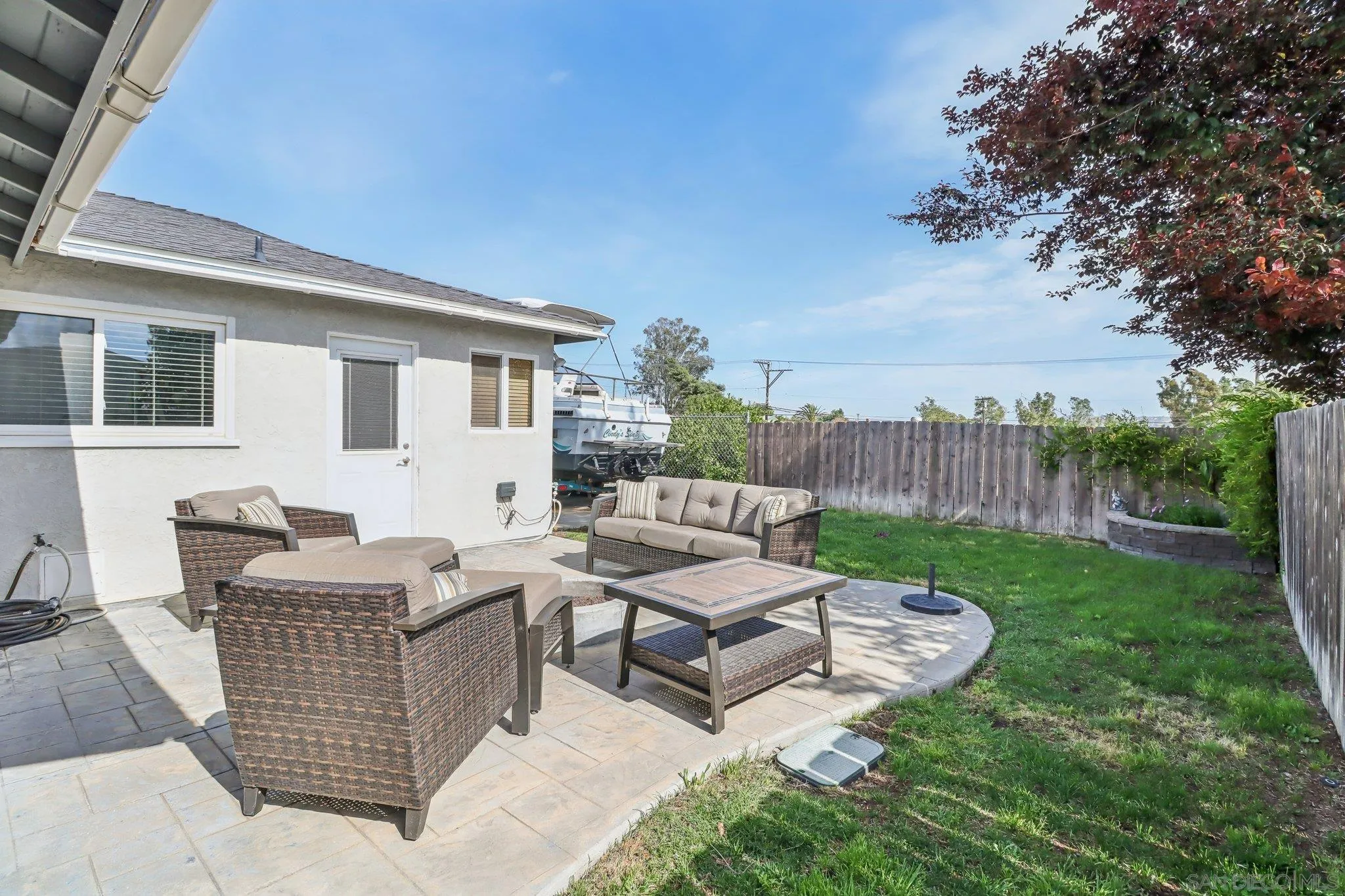 9932 Settle Road Santee, CA 92071 - Photo 37 of 53 a view of a patio with couches and a table and chairs with wooden fence