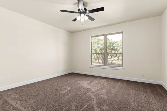 a living room with stainless steel appliances granite countertop furniture and a chandelier