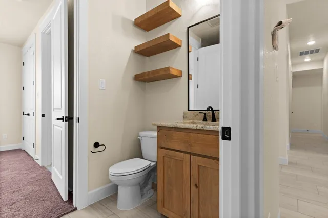 a bathroom with a granite countertop sink and a bathtub