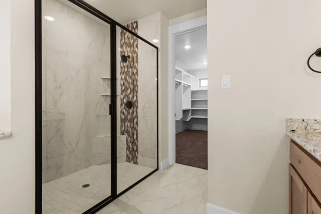 a bathroom with a bathtub shower and a sink