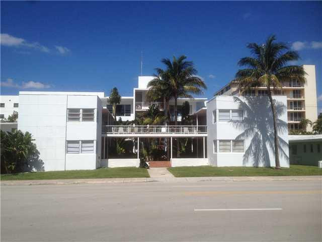 a view of a building with a yard