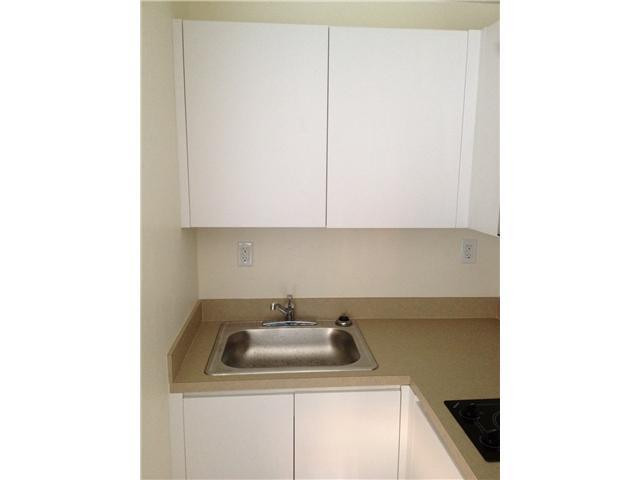 519 North Birch Road, Unit 12 Fort Lauderdale, FL 33304 - Photo 5 of 9 a kitchen with a sink and cabinets