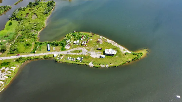 an aerial view of a residential houses with outdoor space and street view