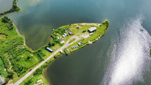an aerial view of a house with a yard basket ball court and outdoor seating