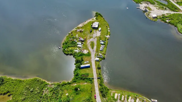 an aerial view of a golf course with a lake