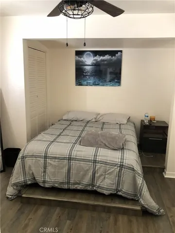 a bedroom with a bed and a wall painting