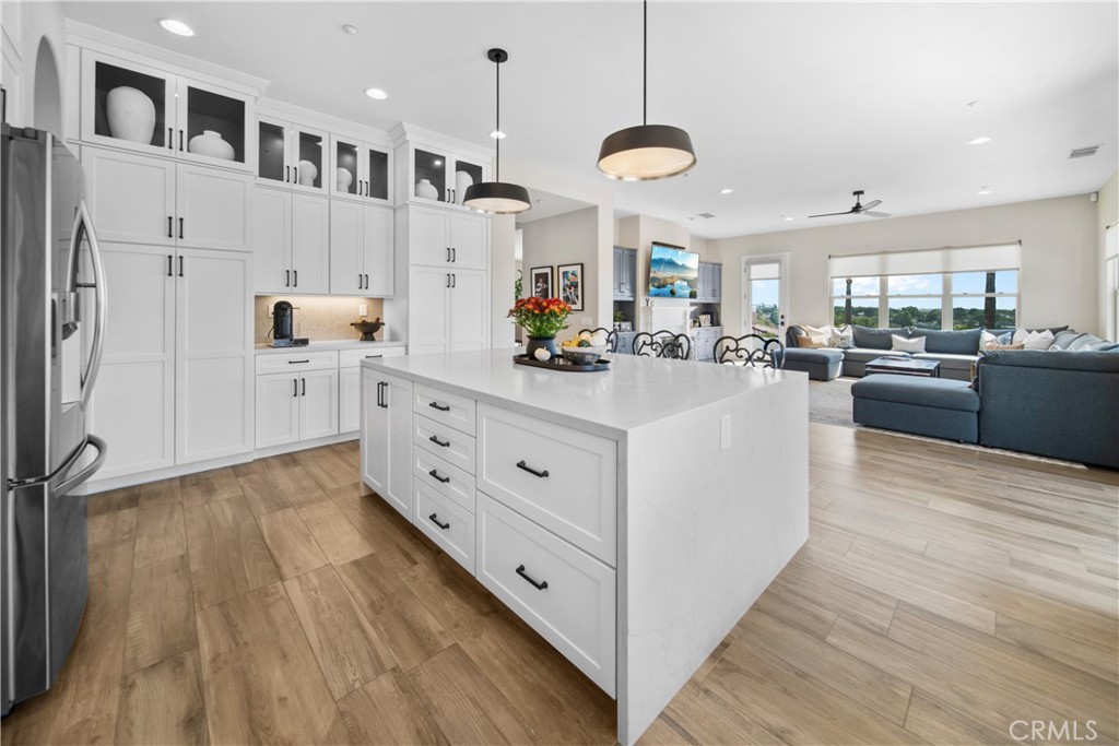 169 Mission Oaks Road Fallbrook, CA 92028 - Photo 15 of 35 a kitchen with stainless steel appliances kitchen island wooden floors cabinets and a center island