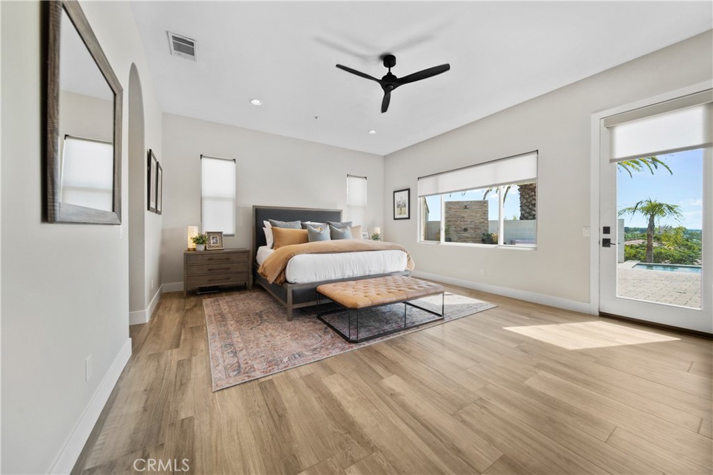 169 Mission Oaks Road Fallbrook, CA 92028 - Photo 22 of 35 a spacious bedroom with a bed and a chandelier