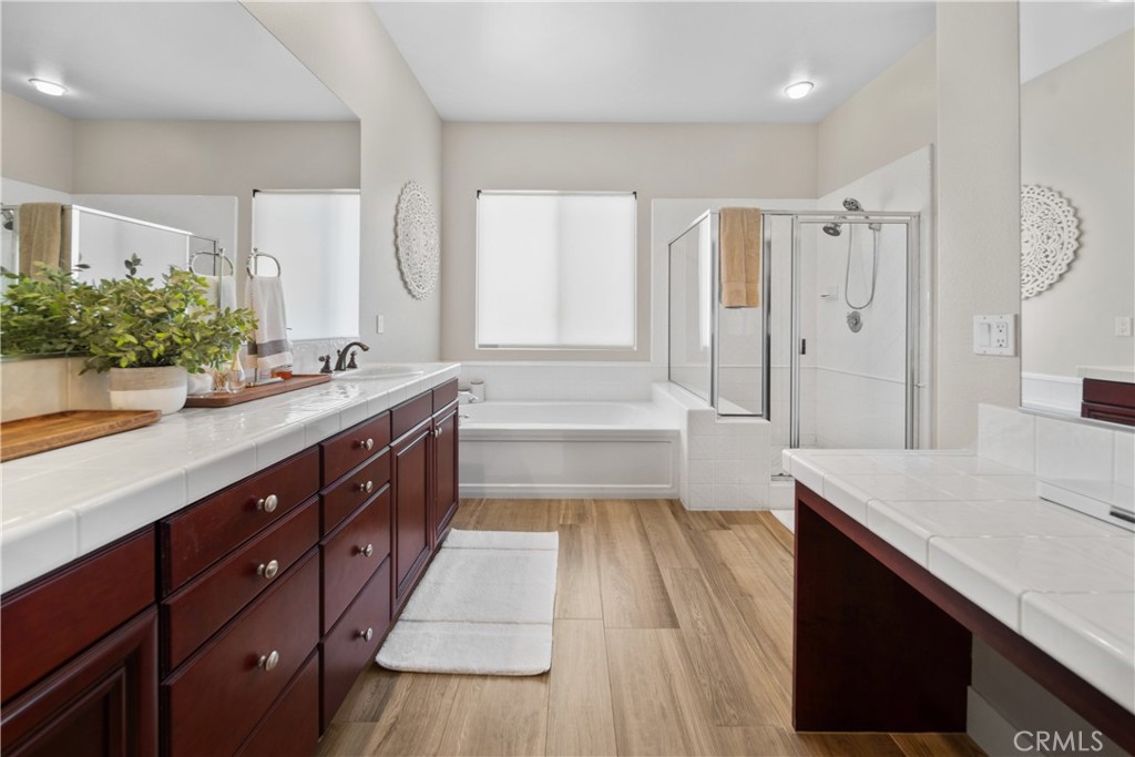 169 Mission Oaks Road Fallbrook, CA 92028 - Photo 24 of 35 a spacious bathroom with a sink double vanity granite tub shower and a mirror