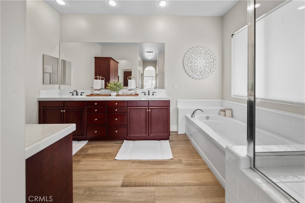 169 Mission Oaks Road Fallbrook, CA 92028 - Photo 25 of 35 a spacious bathroom with a tub double vanity sink and a mirror