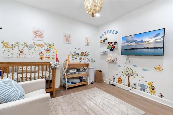 a bedroom with furniture and a flat screen tv