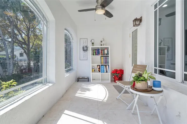 a dining room with furniture and a floor to ceiling window