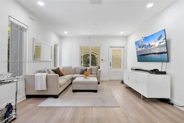 a living room with furniture and a flat screen tv