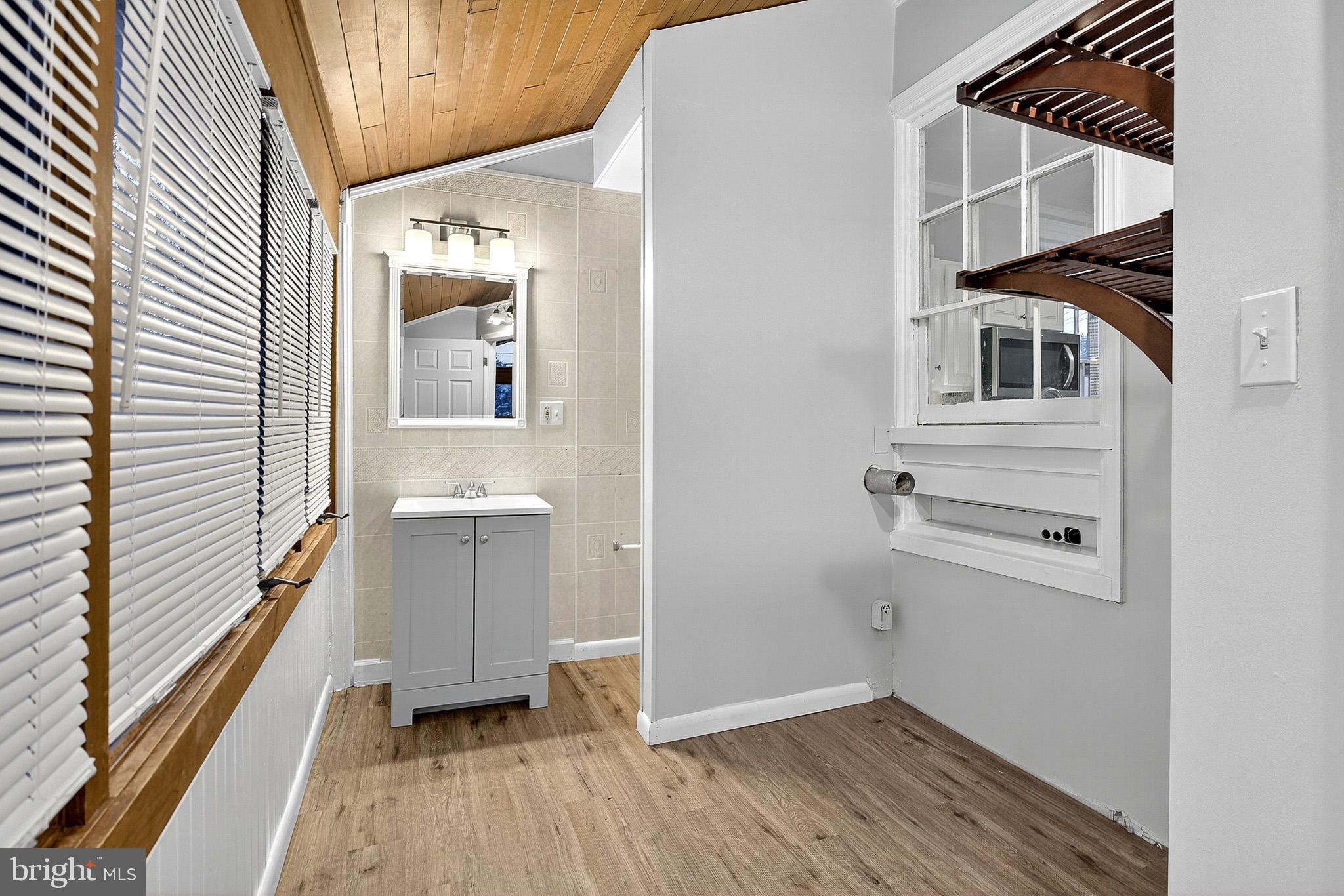 110 Delaware Avenue Elkton, MD 21921 - Photo 17 of 65 a view of a hallway with wooden floor and staircase