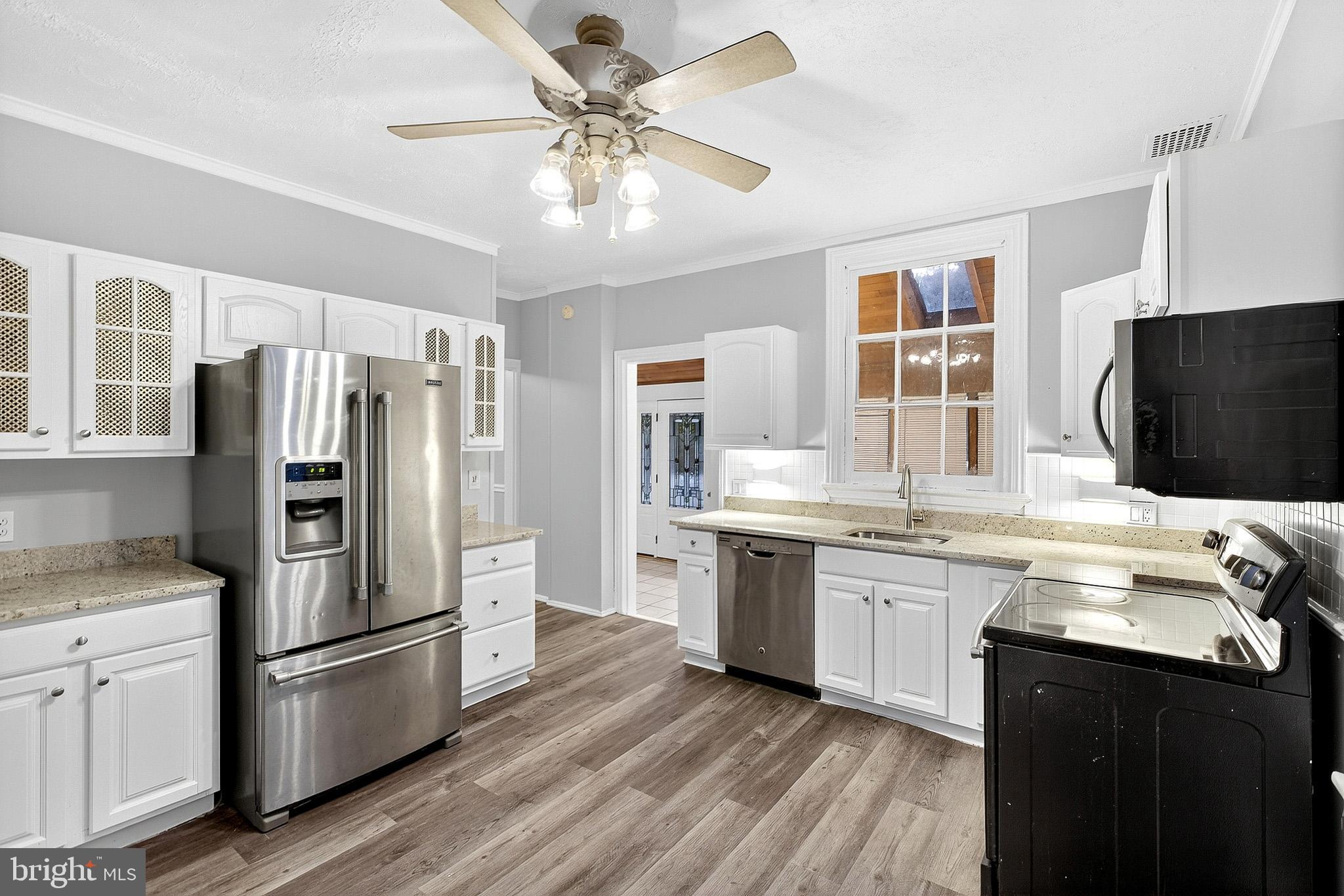 110 Delaware Avenue Elkton, MD 21921 - Photo 23 of 65 a kitchen with stainless steel appliances granite countertop a refrigerator a stove a sink and a microwave