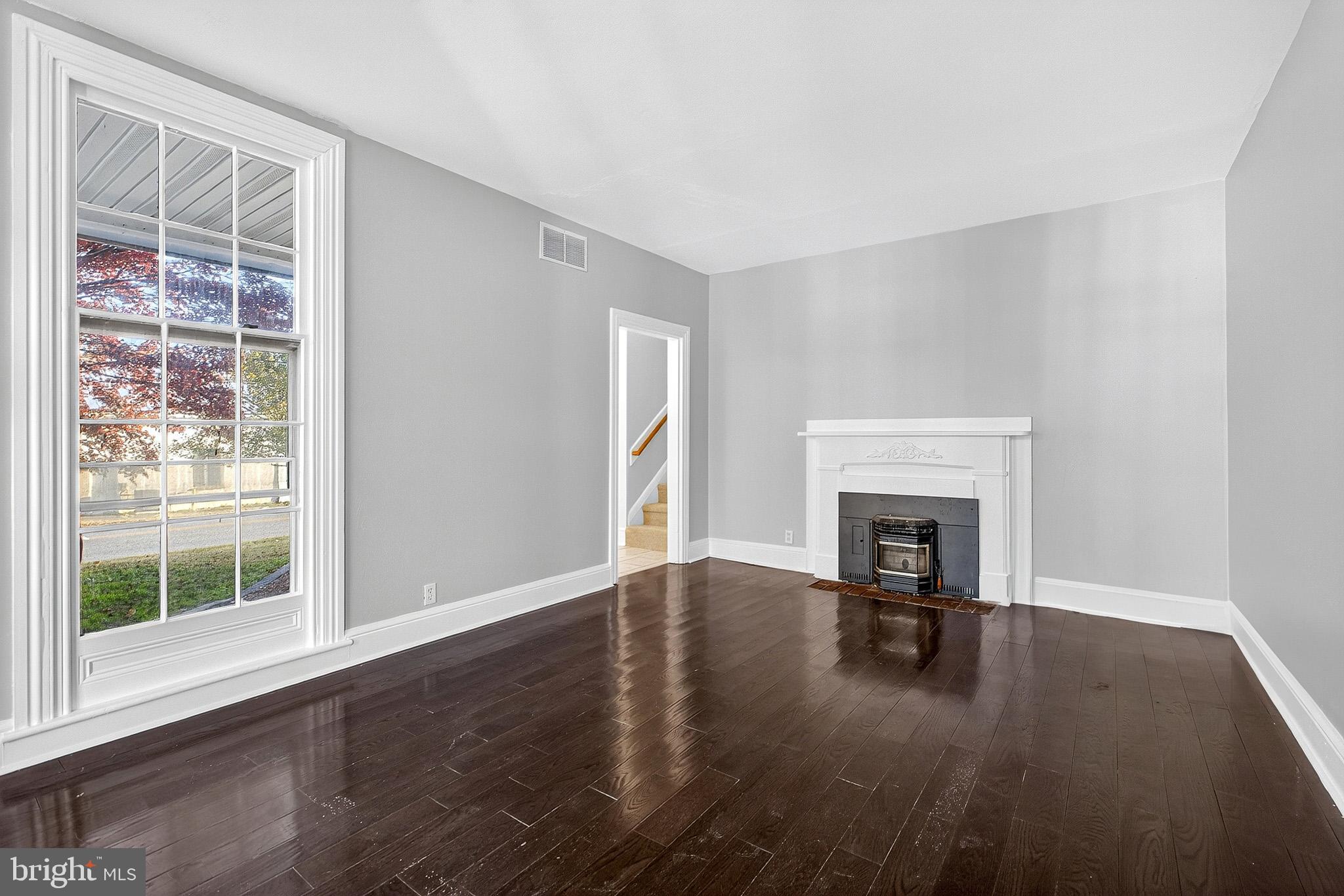 110 Delaware Avenue Elkton, MD 21921 - Photo 29 of 65 a view of empty room with wooden floor and fireplace