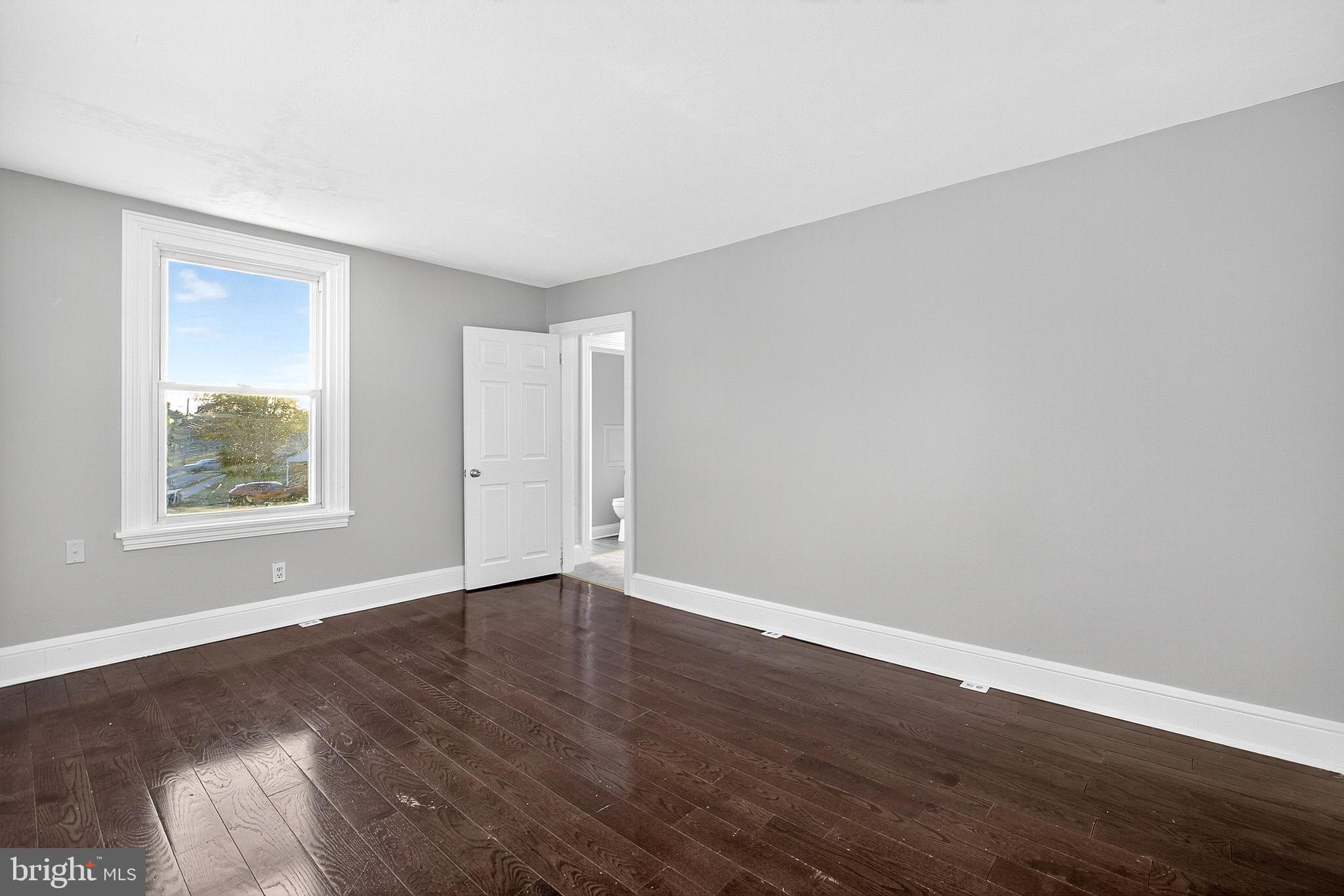 110 Delaware Avenue Elkton, MD 21921 - Photo 37 of 65 a view of an empty room with wooden floor and a window