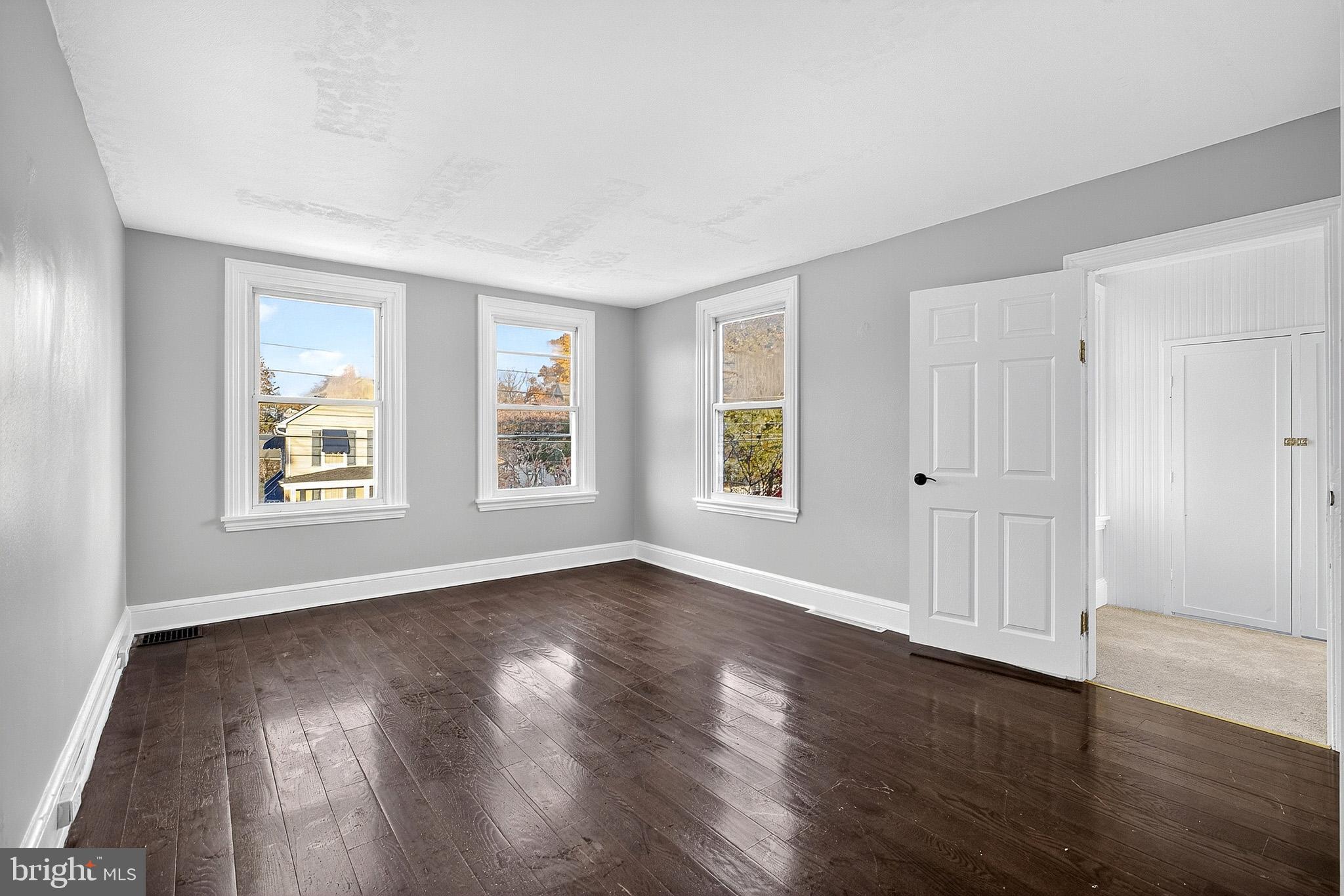 110 Delaware Avenue Elkton, MD 21921 - Photo 45 of 65 a view of an empty room with wooden floor and a window