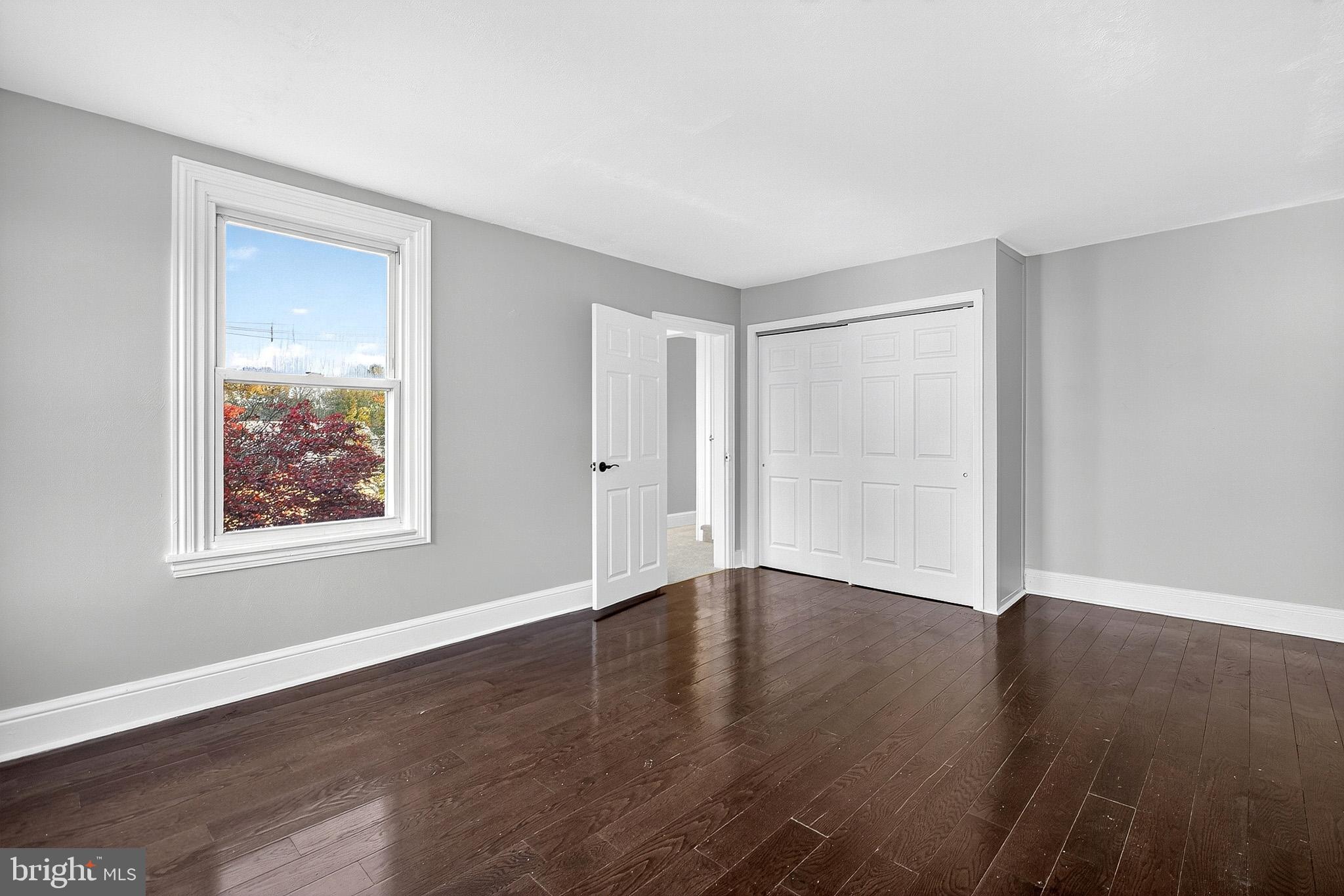 110 Delaware Avenue Elkton, MD 21921 - Photo 46 of 65 a view of an empty room with wooden floor and a window