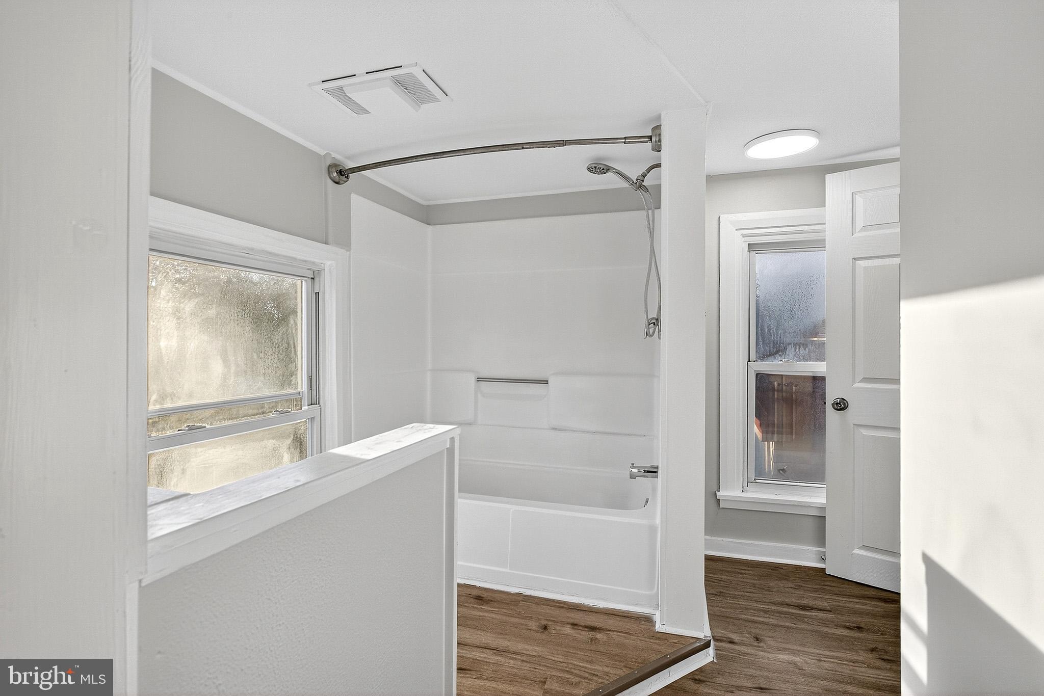 110 Delaware Avenue Elkton, MD 21921 - Photo 54 of 65 a bathroom with a glass shower door and a bathtub