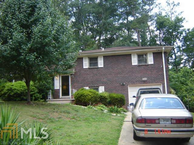 2344 Tiffany Circle, Unit 131 Decatur, GA 30035 - Photo 1 of 1 a car parked in front of a white house
