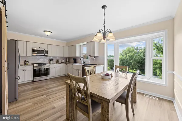 a kitchen with a dining table and chairs