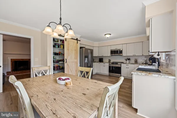 a kitchen with stainless steel appliances a refrigerator sink and cabinets