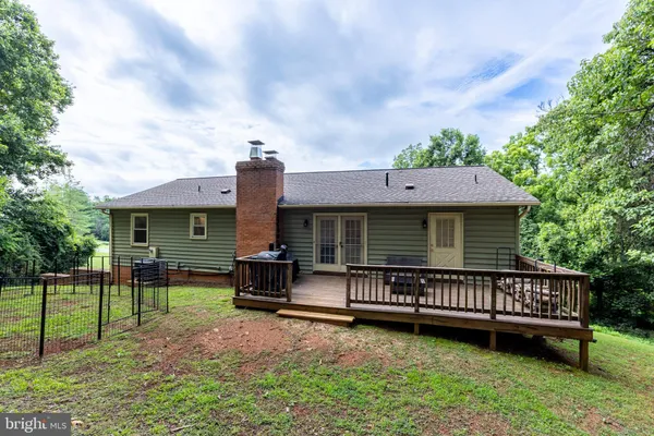 a view of a house with a yard and furniture
