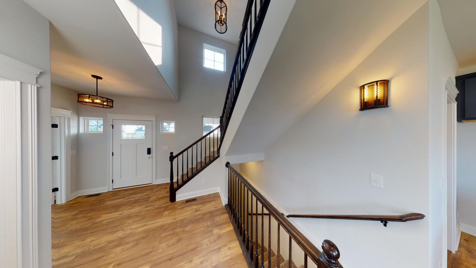 118 Cache Isle Circle Channahon, IL 60410 - Photo 14 of 32 a view of a hallway with wooden floor and stairs